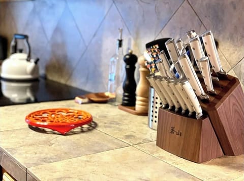 A well-appointed kitchen features chef-quality Le Creuset cookware and knives.