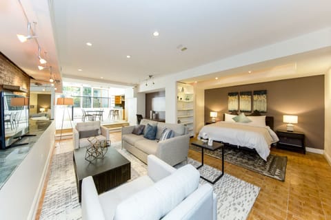 Deluxe Studio Suite | Living area | Flat-screen TV, iPod dock, printers