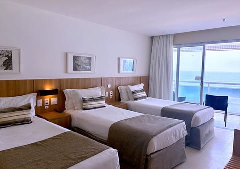 Deluxe Triple Room, Balcony, Sea Facing | Minibar, in-room safe, blackout drapes, iron/ironing board