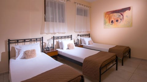 One of the 2 bedrooms with 3 single beds