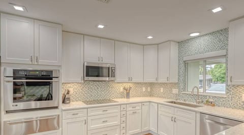 Open layout fully appointed eat in kitchen with island for 4, stainless steel refrigerator with filtered water/ice maker, Keurig machine for pod or regular drip coffee, toaster, microwave, filtered water etc.  Look on listing for a detailed list of everything located  inside kitchen. 