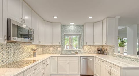 Open layout fully appointed eat in kitchen with island for 4, stainless steel refrigerator with filtered water/ice maker, Keurig machine for pod or regular drip coffee, toaster, microwave, filtered water etc.  Look on listing for a detailed list of everything located  inside kitchen. 