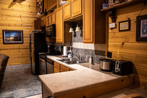 Cabin | Private kitchen | Microwave, cleaning supplies, paper towels, dining tables