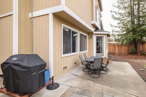 Backyard with propane BBQ and dining tables. Fully fenced.