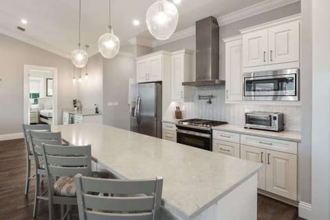 Gourmet kitchen equip with blender, Keurig coffee machine, crockpot, lots of cookware, and enough dishes and dining utensils for everyone.