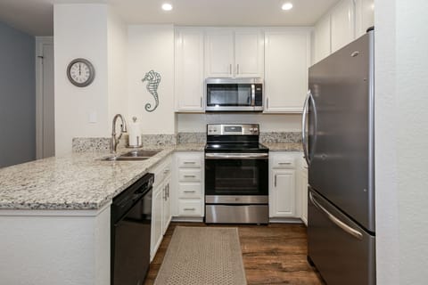 Fully stocked kitchen with stainless steel appliances