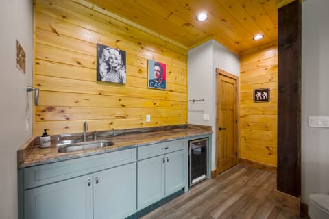 Game room includes a wet bar and mini fridge