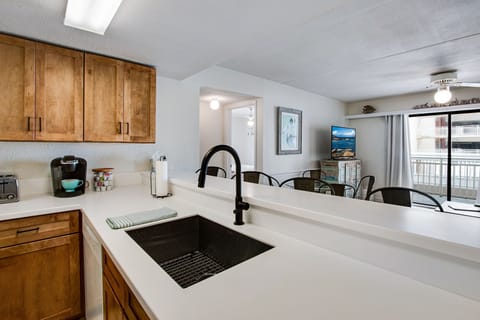New cabinets, countertop, and sink in the well-stocked kitchen