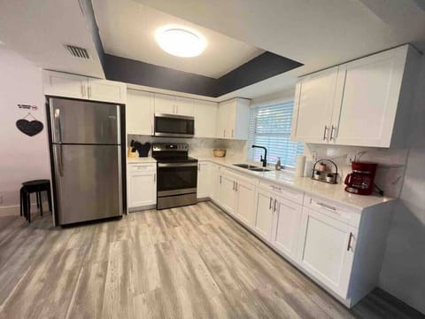Open concept full kitchen with a fridge, oven, stovetop, coffee pot, toaster and anything else you might need to feel at home! The kitchen is fully equipped with anything you need for a home cooked meal