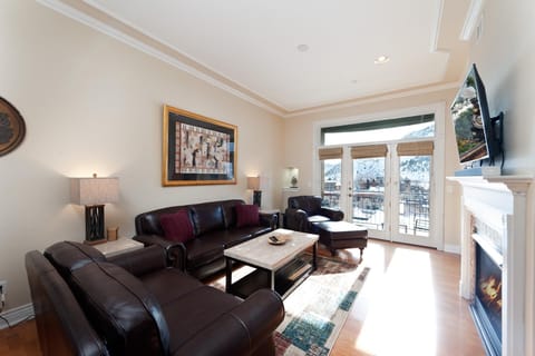 Downtown Durango Condo - Mears 3C. Living room with fireplace, tv, and mountain views. Located right across the street from the historic train.