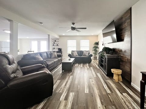 Living Room with love seat, couch and recliner to sit and relax on.