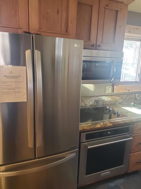 Picture of shared kitchen 2 stoves microwave, shared refrigerator and freezer.