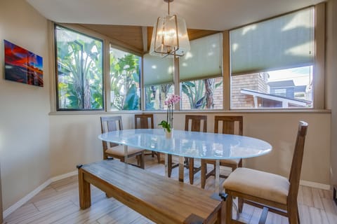 Dining for 6 at this spacious table surrounded by windows.