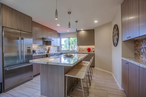 Large upgraded kitchen with bar seating for three people.
