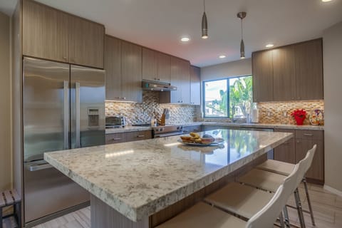 Upgraded appliances and a large kitchen island for cooking the perfect meal.