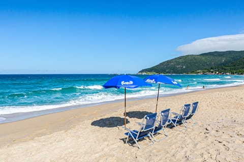 On the beach, white sand, beach umbrellas, beach towels