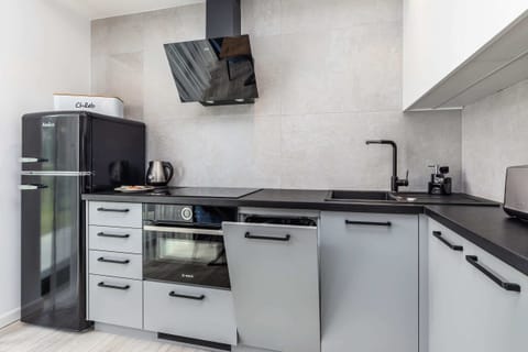 Kitchen area with a modern electric stove and black countertop, minimalistic and functional.