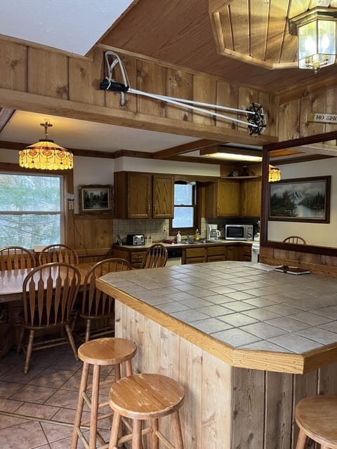 Counter top with seating, dining area and kitchen. 