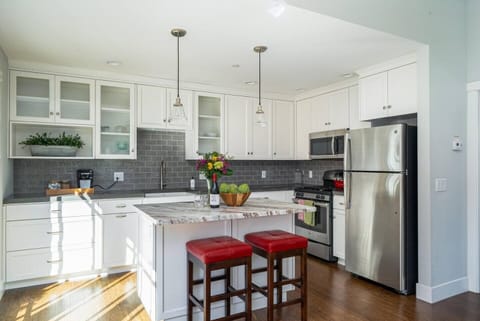 Full kitchen and island for more cooking space. Fridge and freezer.