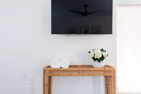 50 inch TV, swivels on wall-mounted hardware for easy viewing from couch or bed