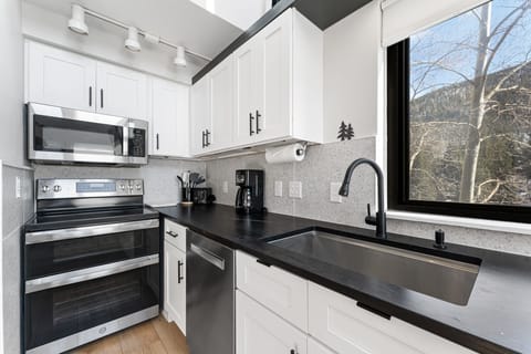 Updated full-size kitchen with stainless steel appliances and new countertops.
