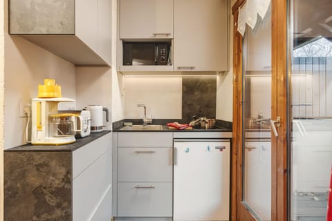 Practical kitchen next to the balcony access