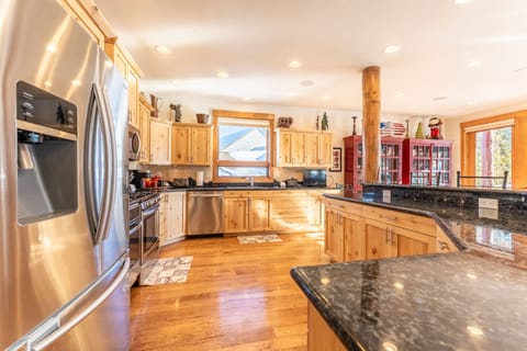 Spacious updated kitchen with modern stainless steel appliances, granite countertops and small flat screen TV.