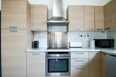 Luxury Apartment | Private kitchen | Fridge, electric kettle, dining tables