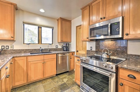 Kitchen fully stocked with dishware and cookware. Traditional drip coffee maker