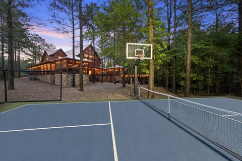 Huge backyard with lighted pickleball court, big fire-pit, custom playset with two slides, and lots of open play space.