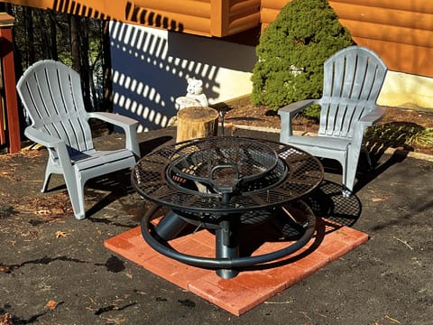 Fire pit area on driveway with two Adirondack chairs (additional available)