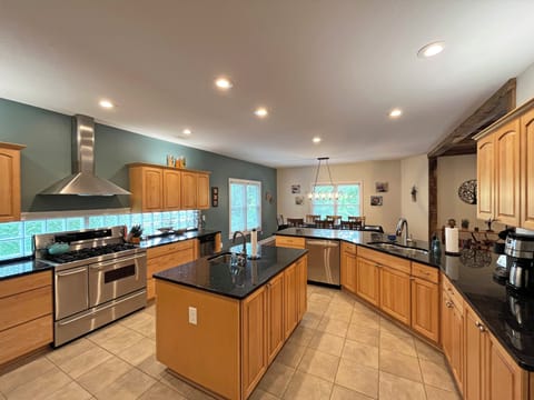 The Kitchen is spacious with large island and 2 sinks. Gas cooktop, double ovens, and lots of counter space, make it easy for families to share in the cooking experience.