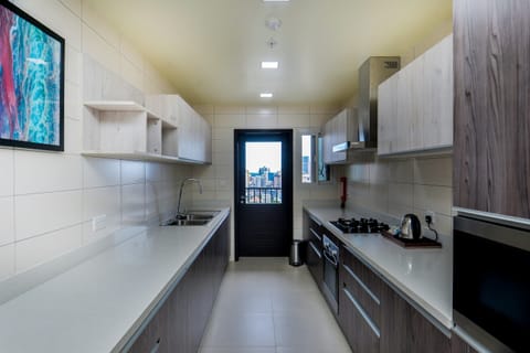 Premium Suite, 3 Bedrooms | Private kitchen | Full-size fridge, oven, coffee/tea maker, electric kettle