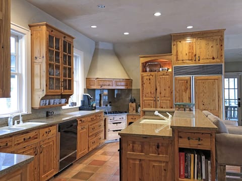 Well-stocked Kitchen includes gas cook top, 2 sinks, beautiful custom cabinets and lots of work-surface... perfect cooking space for larger groups and holidays.