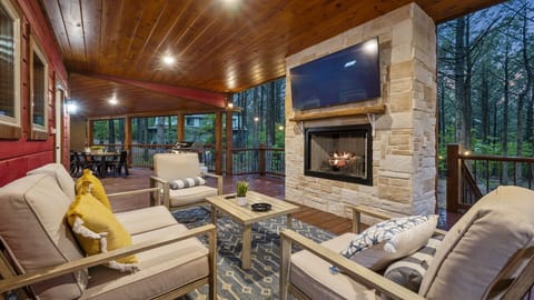 Outside furniture, Fireplace, TV, Seating and Hot Tub around the corner