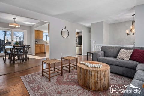 - Open layout seamlessly connects the living room to kitchen and hallway for easy flow
- Neutral walls and wood flooring create a warm, cohesive base throughout the home
- Ideal for hosting, relaxing, or watching a movie on the cozy gray sectional