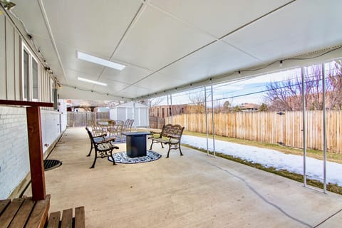 Large covered patio, 6 seated table and 2 bench seats around fire pit.