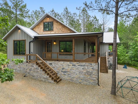 Embrace the charm of Broken Bow with this cozy cabin featuring a stunning wraparound porch—your perfect getaway in the heart of nature. 