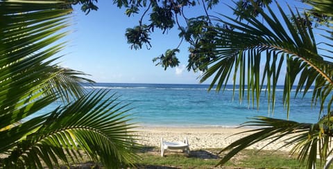 On the beach, white sand, sun loungers, beach towels