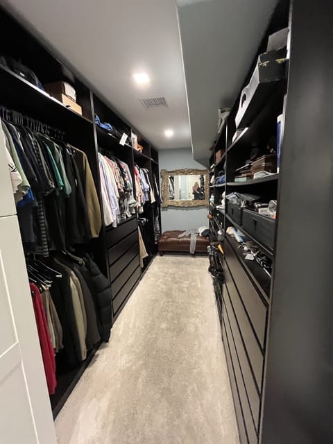 Master closet with lots of drawers, shelfs and hanging