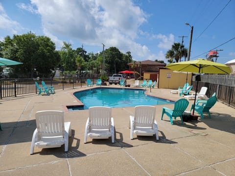 Seasonal outdoor pool, open 9:00 AM to 11:00 PM, pool umbrellas