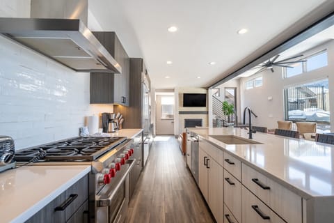 Luxury full-sized kitchen with high-end stainless steel appliances, granite countertops, tons of cabinet space, and dedicated wine fridge.