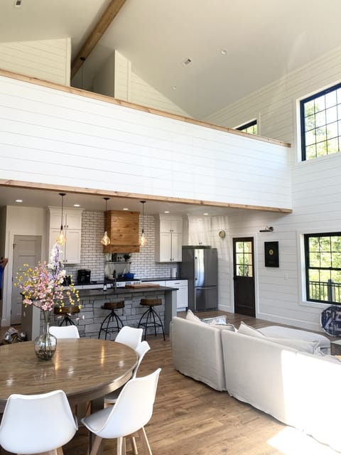 Open Living space with 2 tables, wrap around comfy couch and tons of light!