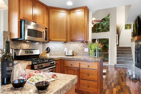 Warm wood tones wrap around you in this convenient kitchen