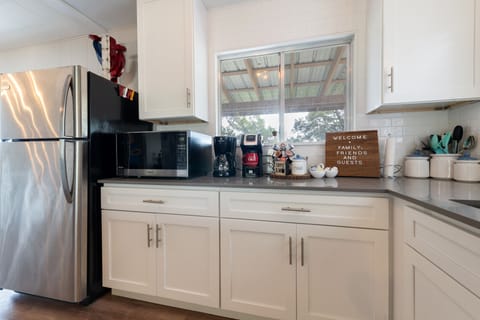 Full fridge and freezer, microwave and coffee station