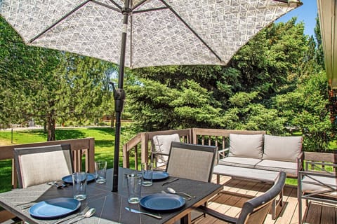 Deck with dining table, umbrella, and lounge chairs