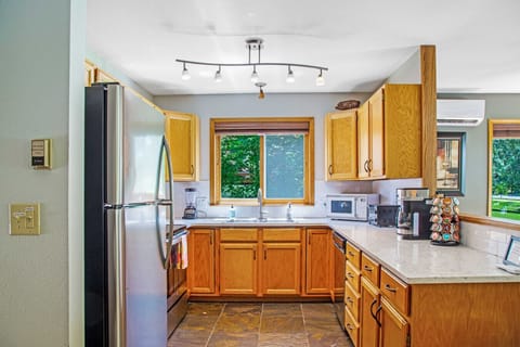 Kitchen with quartz countertops, oven/range, dishwasher, microwave, coffee maker, Keurig, toaster, blender, kitchen and dinnerware.