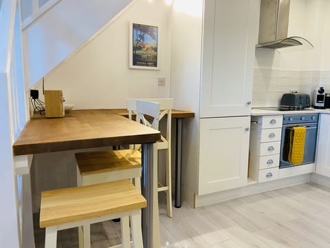 The breakfast bar sits up to 3 people with electrical points and fabulous views.