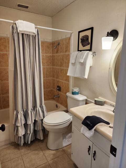 Classic Cabin, Fireplace, Courtyard View | Bathroom | Combined shower/tub, hair dryer, towels, soap