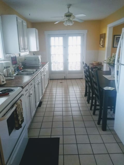Large kitchen is fully stocked with pots, pans, dishes and utensils!